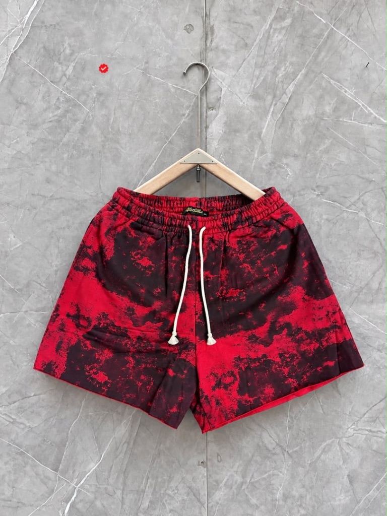 tie-dye or grunge-patterned drawstring shorts with a white waistband cord.