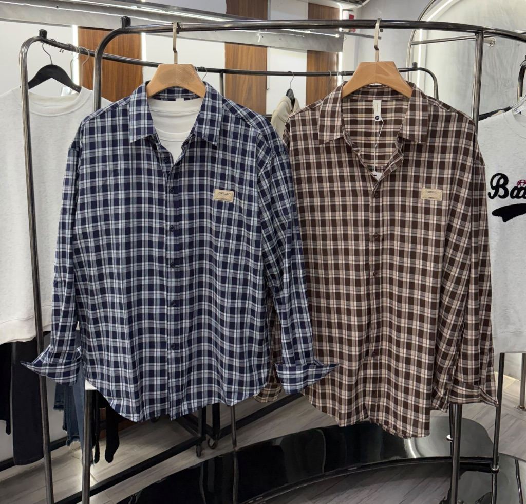 long-sleeve, pinstriped button-down casual shirts with a chest pocket and small embroidered lettering.